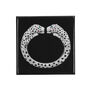 A square black magnet featuring Cartier's twin-headed diamond panther bangle