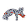 The likeness of a diamond-studded panther lounging on a branch hand sewn in silver, blue, and terracotta threads