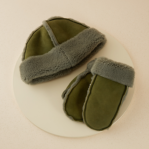 A matching pair of green and grey mittens and winter hat.
