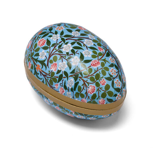 A paper box in the shape of an egg featuring an Arts and Crafts botanical pattern.