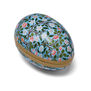 A paper box in the shape of an egg featuring an Arts and Crafts botanical pattern.