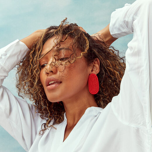 Red oval stud earrings by Inzuki