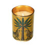 A lit up candle in a cylindric golden jar.