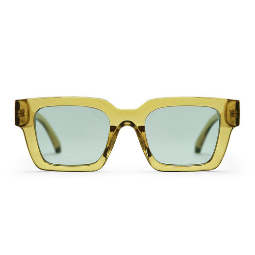 A pair of sunglasses with a boxy transparent green frame.