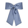 A pastel blue hair clip in the shape of a maxi bow. 