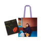 A tote bag and a hardback book on a white background. On the book cover is a red poppy on a black background; the tote features a photograph of a man sitting at a dining table.