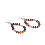 A pair of hook earrings with multicoloured beads arranged in a drop shape lying on a white surface.