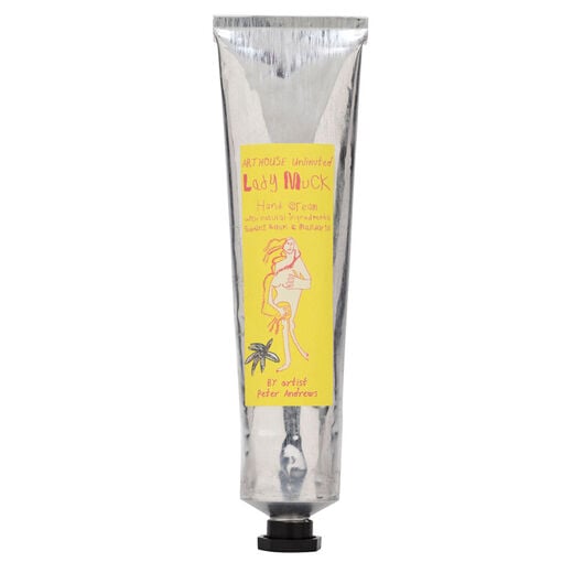 A silver hand cream tube with a black cap and a yellow label featuring an artwork by ARTHOUSE Unlimited artist Peter Andrews.