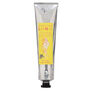 A silver hand cream tube with a black cap and a yellow label featuring an artwork by ARTHOUSE Unlimited artist Peter Andrews.