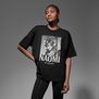 A young black model wearing a black oversized t-shirt with a black and white photo printed on the chest.