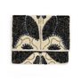 A velvet clutch encrusted with blue, black and white beads.