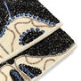 A close up of a clutch bag embellished with a pattern of blue and black beads.