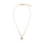 A gold chain necklace with a star shaped pendant.