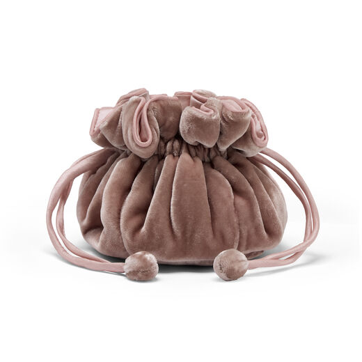 Pink velvet drawstring pouch for storing jewellery.
