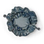 Blue velvet drawstring pouch with inner pockets for storing jewellery.