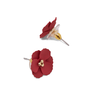 Two deep red flower-shaped stud earrings are displayed on a white surface. 