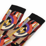 A detail shot of a pair of black socks with an Art Deco pattern.