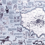 A detail of a blue and white tea towel with illustrations of dogs over a map of London.