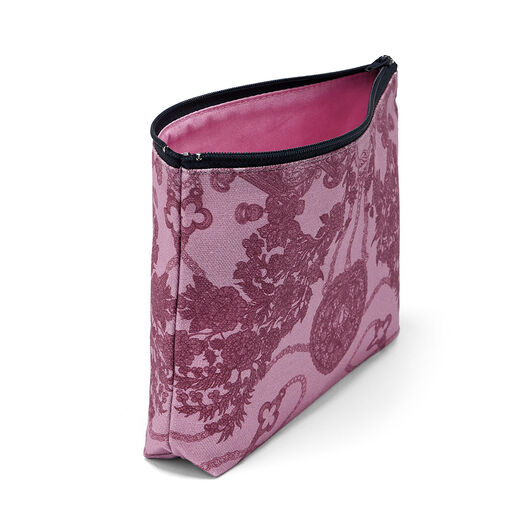 A pink pouch with a navy zip featuring an intricate illustration of various pieces of jewellery.
