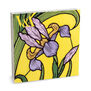 A notecards pack featuring a floral pattern with purple iris on a bright yellow background.