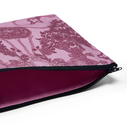 A close up of a pink pouch and its navy blue zip.