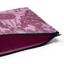 A close up of a pink pouch and its navy blue zip.