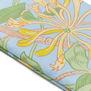 Detail of an oven glove featuring a blue, green and yellow honeysuckle pattern.