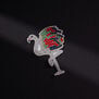 The likeness of a diamond and gemstone Flamingo, sewn in silver, red, green and blue threads 