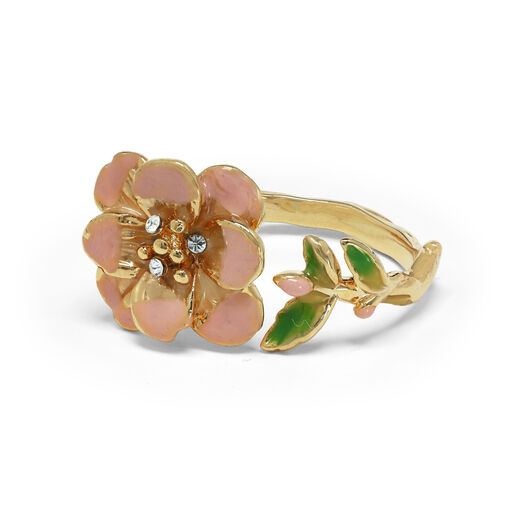 The ring golden metal band is topped with a pink flower and green leaves.