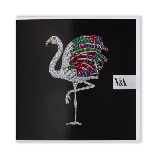 A square black greetings card featuring a flamingo-shaped brooch made of diamonds and coloured gemstones