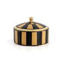 A trinket box in the shape of a black and brown striped circus tent.