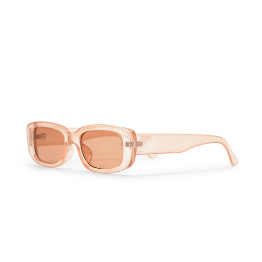 A pair of sunglasses with a transparent thick frame and pink tinted lenses.