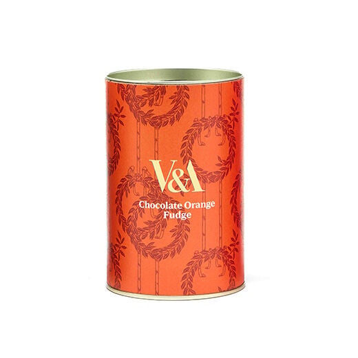 A drum of chocolate orange fudge. The drum is covered in an orange paper label with the V&A logo in white capital letters.