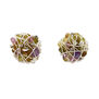 Clip on earrings made with wrapped silver wire and green and purple precious stones.