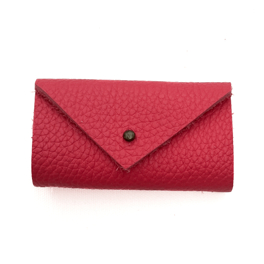 A pink leather needle case cropped against a white background.