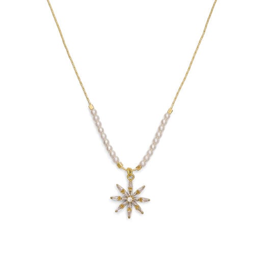 A crystal star shaped pendant on a gold chain with white pearls.