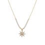 A crystal star shaped pendant on a gold chain with white pearls.