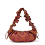 Red ruffle bag with blue and green stich details.