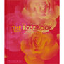 Hardback cover of The Rose Book, with a red, pink and orange print design inspired by the flower.