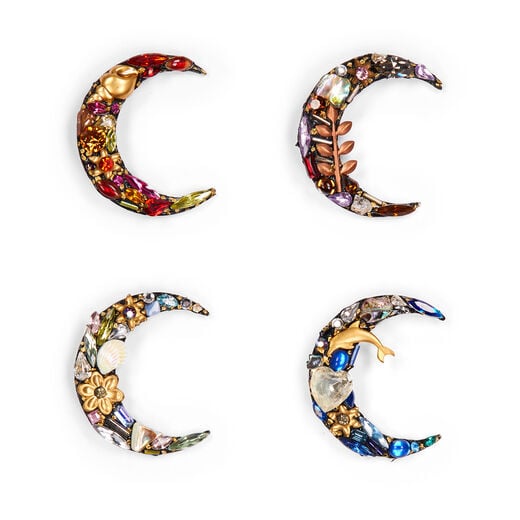 Four brooches in the shape of a crescent moon, each featuring colourful gleaming stones and glass beads.