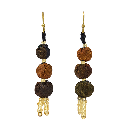 A pair of hook earrings made of three silk beads in neutral colours.