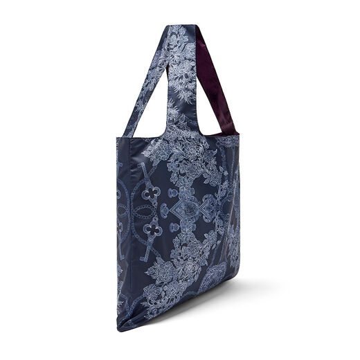 A navy blue tote bag featuring an intricate illustration of jewellery, seen from the side.