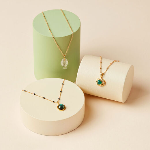 Three pendant necklaces with dainty gold chains.