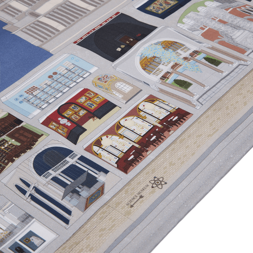 A detail of a tea towel with an illustration of the V&A museum facade. The building is sectioned to show the museums galleries and artworks.