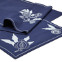 A close up of a blue table runner with white embroidered floral details.