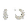 A pair of crescent shaped silver earrings, with silver beads wrapped around the centre.