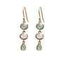 A pair of gold hook earrings featuring three stones in a white and grey gradient.