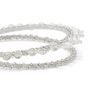 A detail of a metallic headband embellished with glass beads of various sizes.