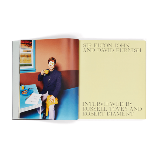 A book spread. The left page features a colour photograph of a man sitting at a breakfast table; the right page has black text on a light yellow background.