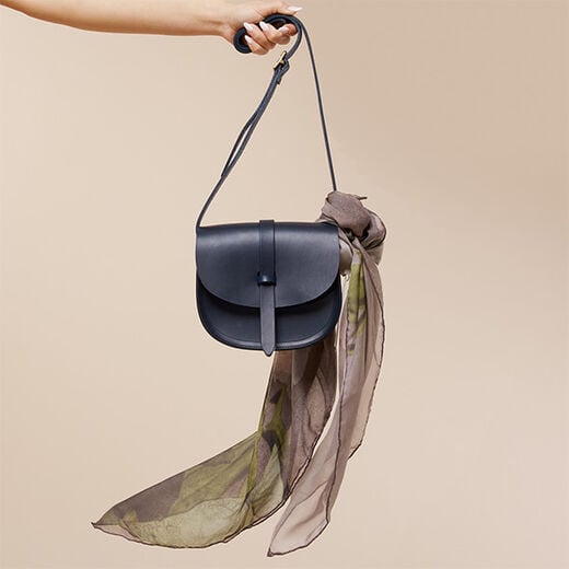 Dark blue leather saddle bag by Natthakur
